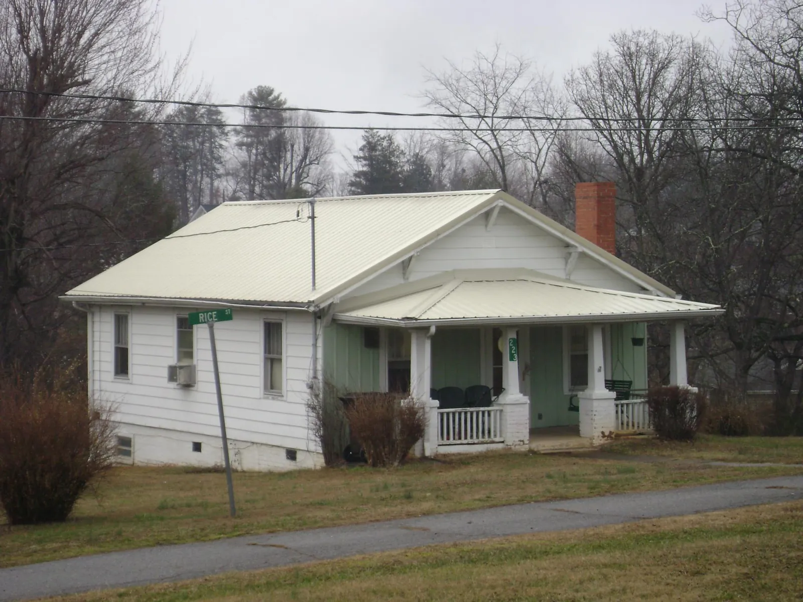 White metal roof on a craftsman bungalow at a street corner in Oilville